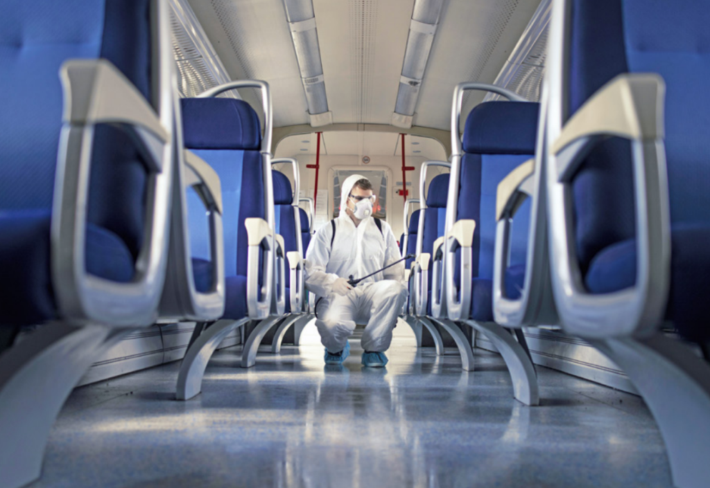 man disinfecting train